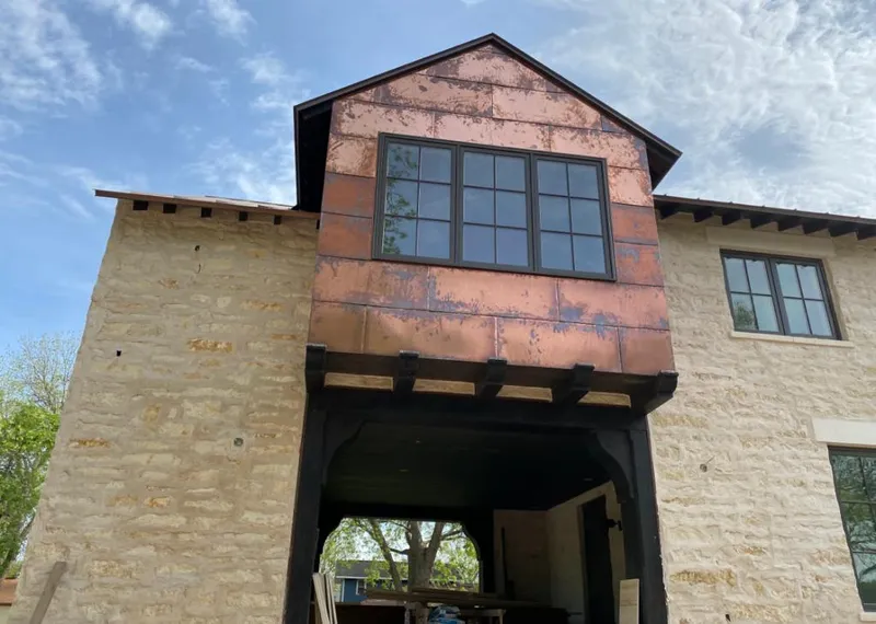 Copper metal panel facade on a stone building for Roof Repair in Gilbert